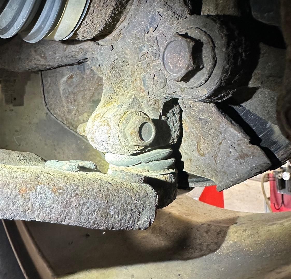 A close up of a rusty piece of metal on a car  | Lou's Car Care Center, Inc.