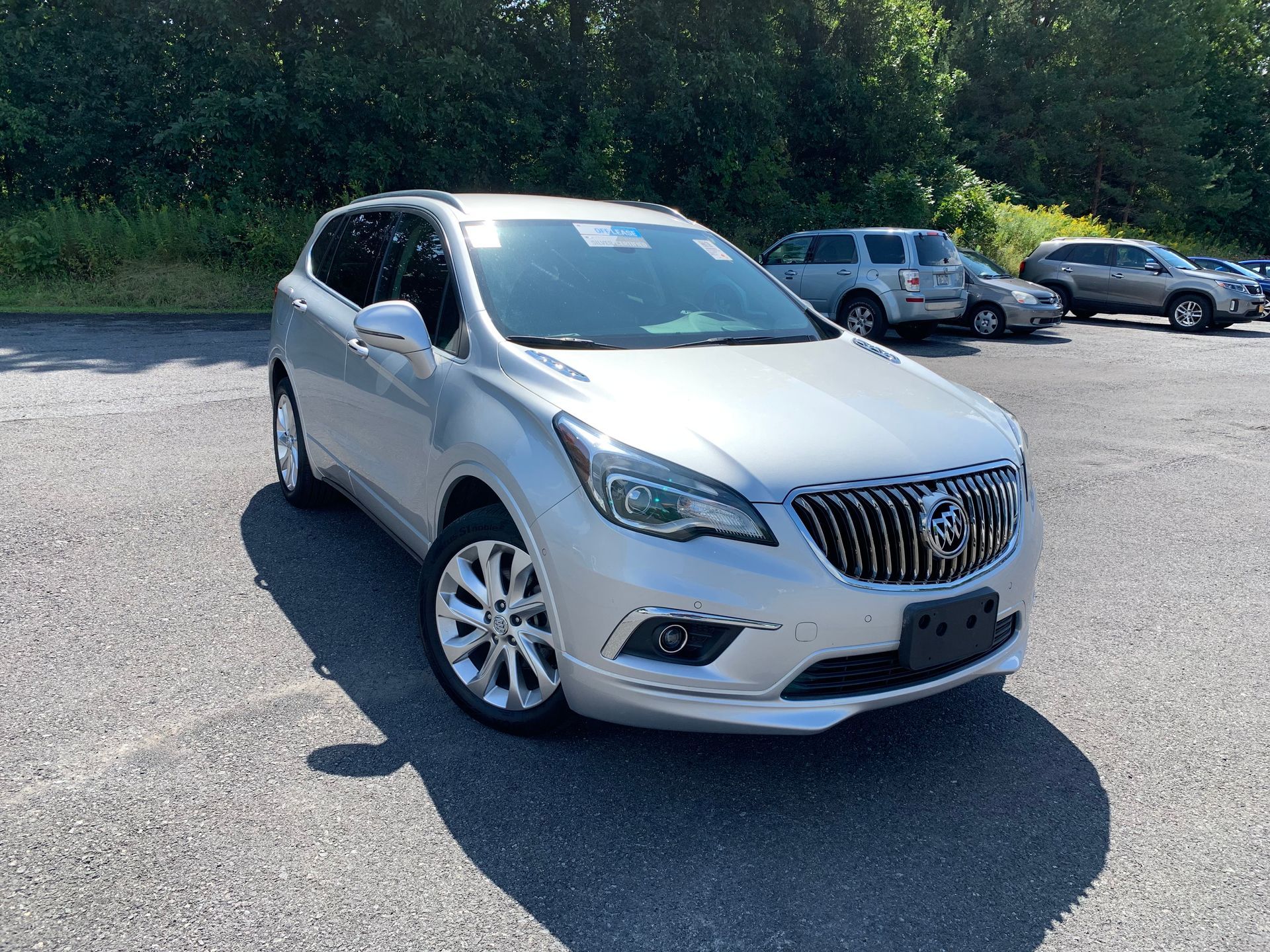 A silver buick enclave is parked in a parking lot. | Lou's Car Care Center, Inc.