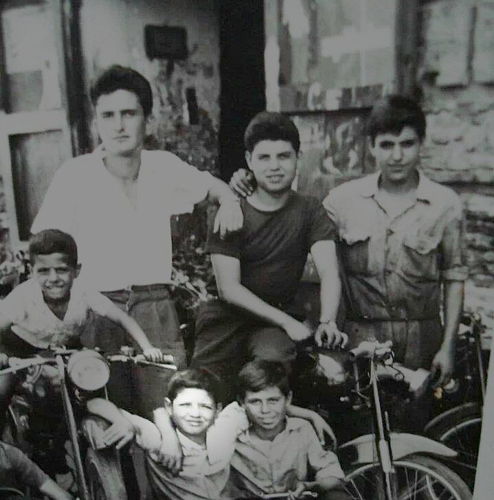 A black and white photo of a group of young men sitting on motorcycles | Lou's Car Care Center