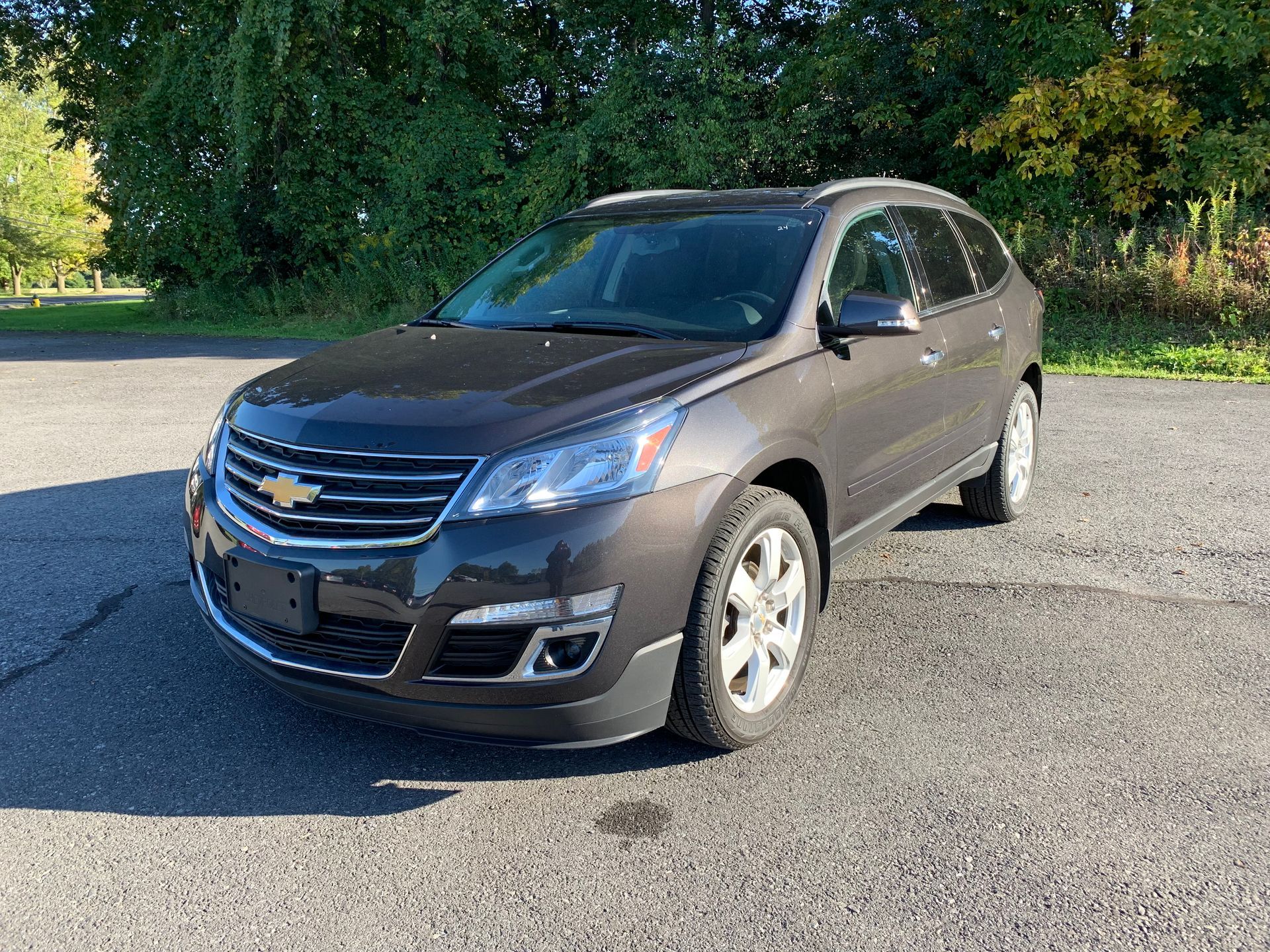 A black chevrolet traverse is parked on the side of the road. | Lou's Car Care Center, Inc.