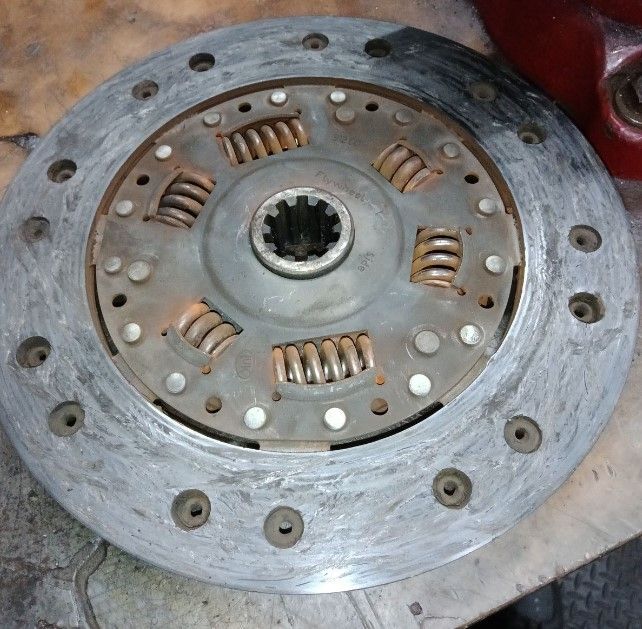 A close up of a clutch disc on a table  | Lou's Car Care Center, Inc.