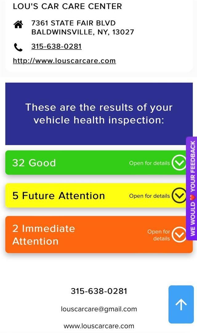 A phone screen shows the results of a vehicle health inspection | Lou's Car Care Center, Inc.