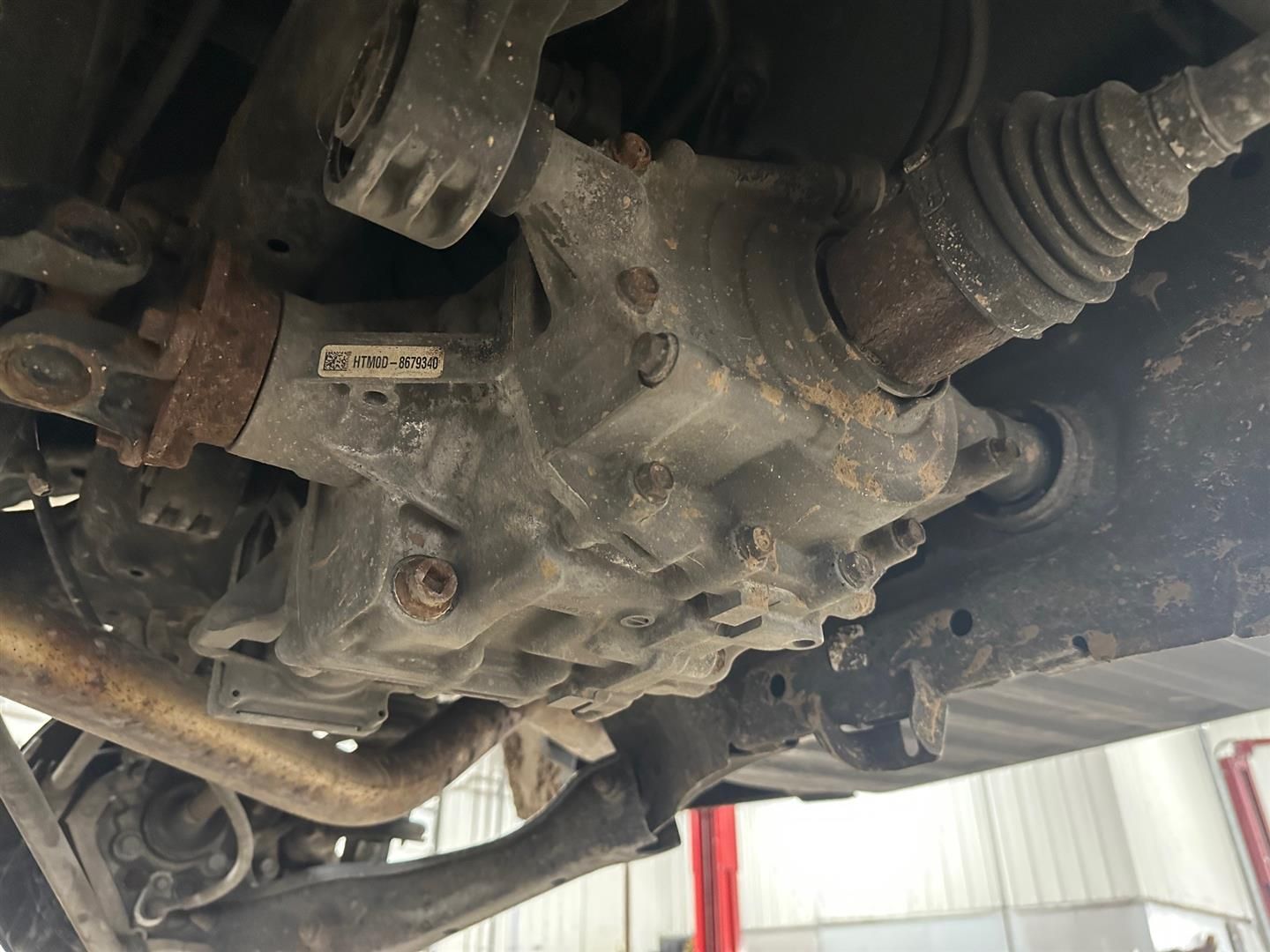 A close up of the underside of a car on a lift. | Lou's Car Care Center, Inc.