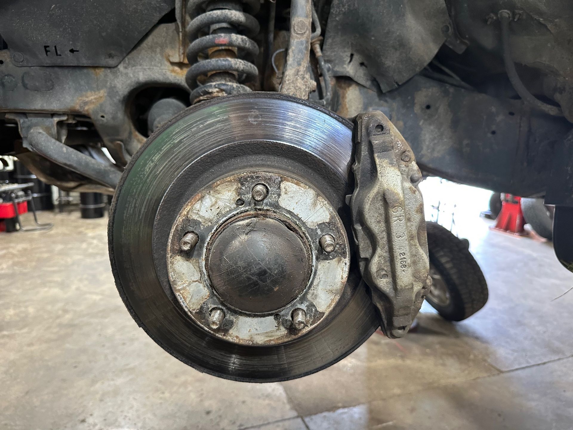 Disc brakes on vehicle in the shop | Lou's Car Care Center, Inc.