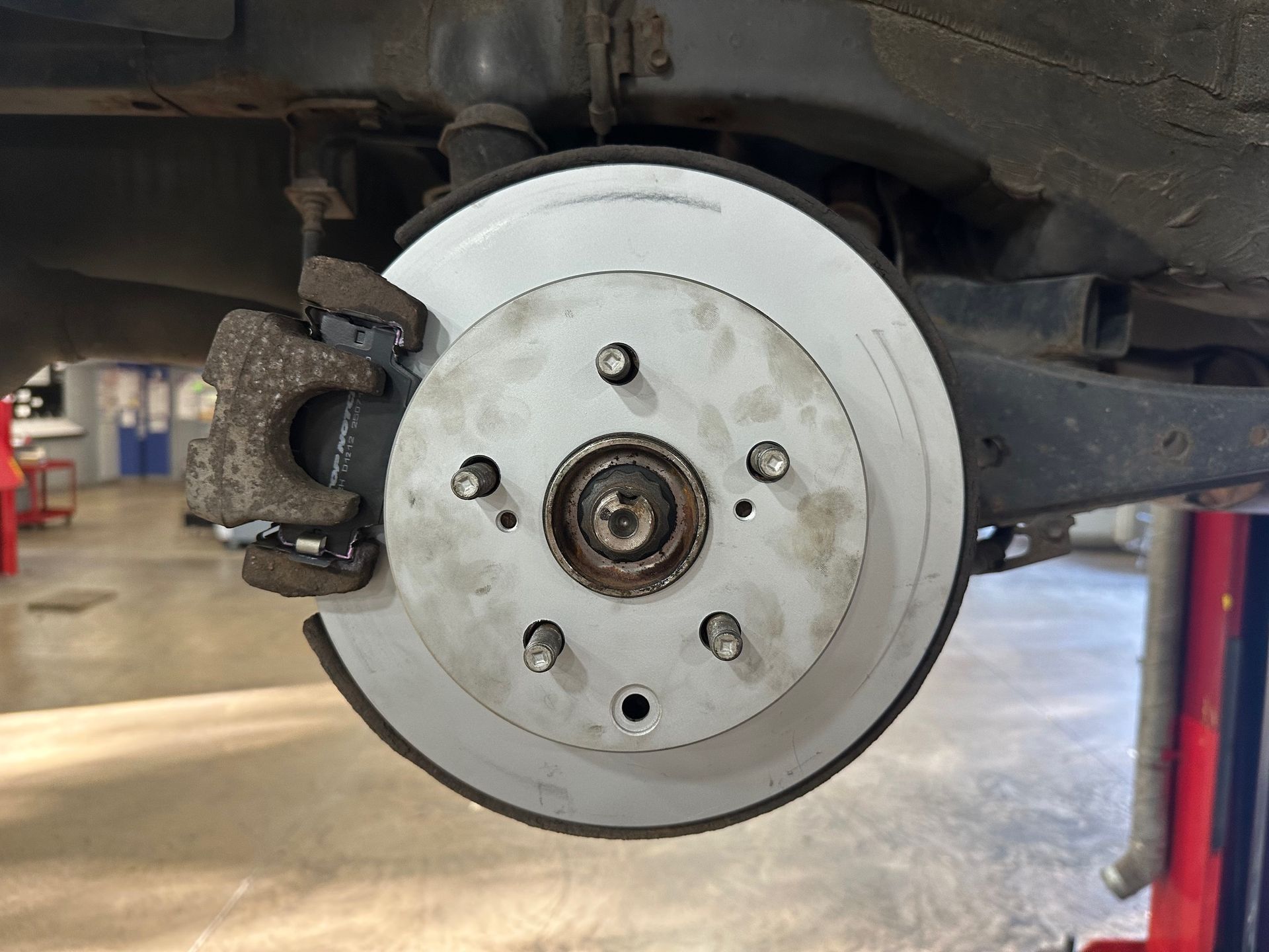 Disc Brakes on vehicle in shop | Lou's Car Care Center, Inc.