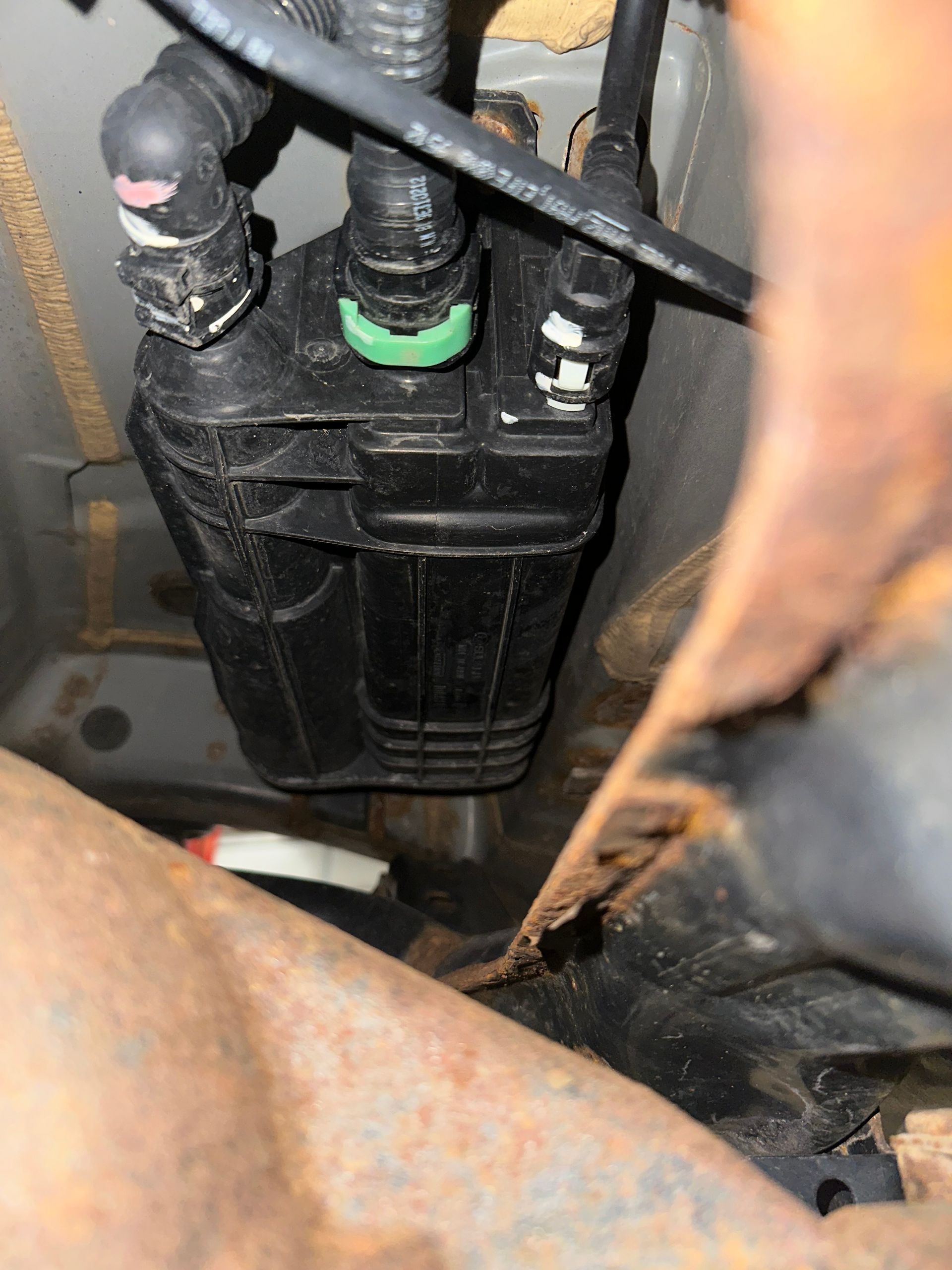 Black EVAP Canister under vehicle in shop | Lou's Car Care Center, Inc.