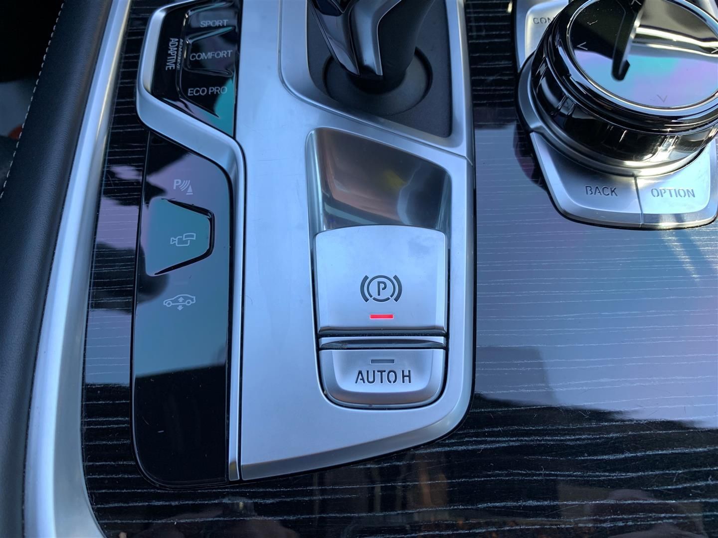 A close up of a car dashboard with a hand brake button. | Lou's Car Care Center, Inc.