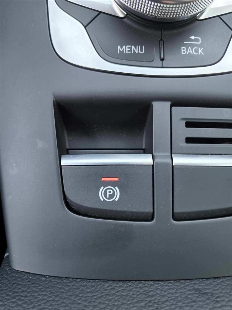 A close up of a car dashboard with a menu and back button | Lou's Car Care Center, Inc.