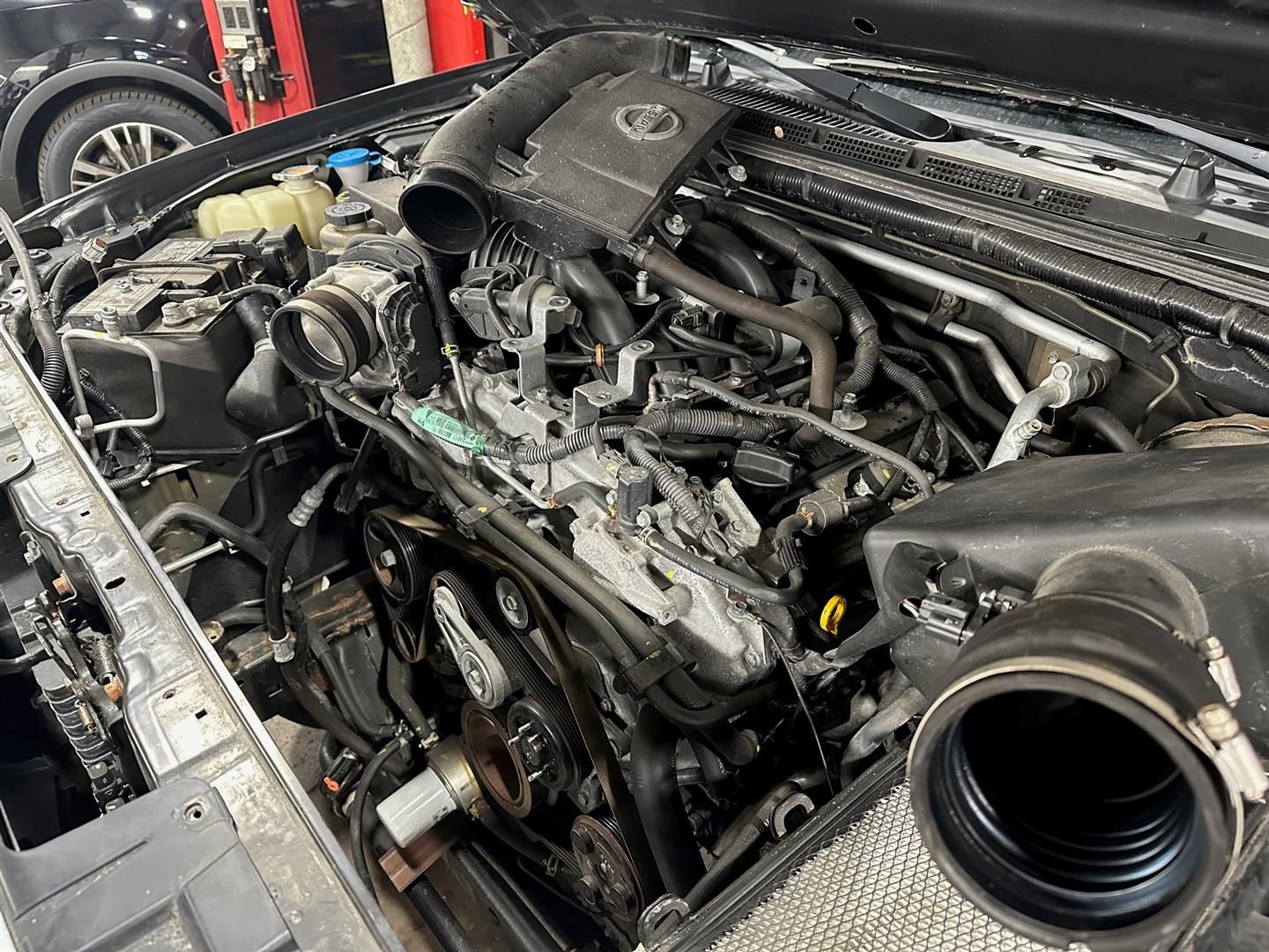 A close up of a car engine with the hood open. | Lou's Car Care Center, Inc.