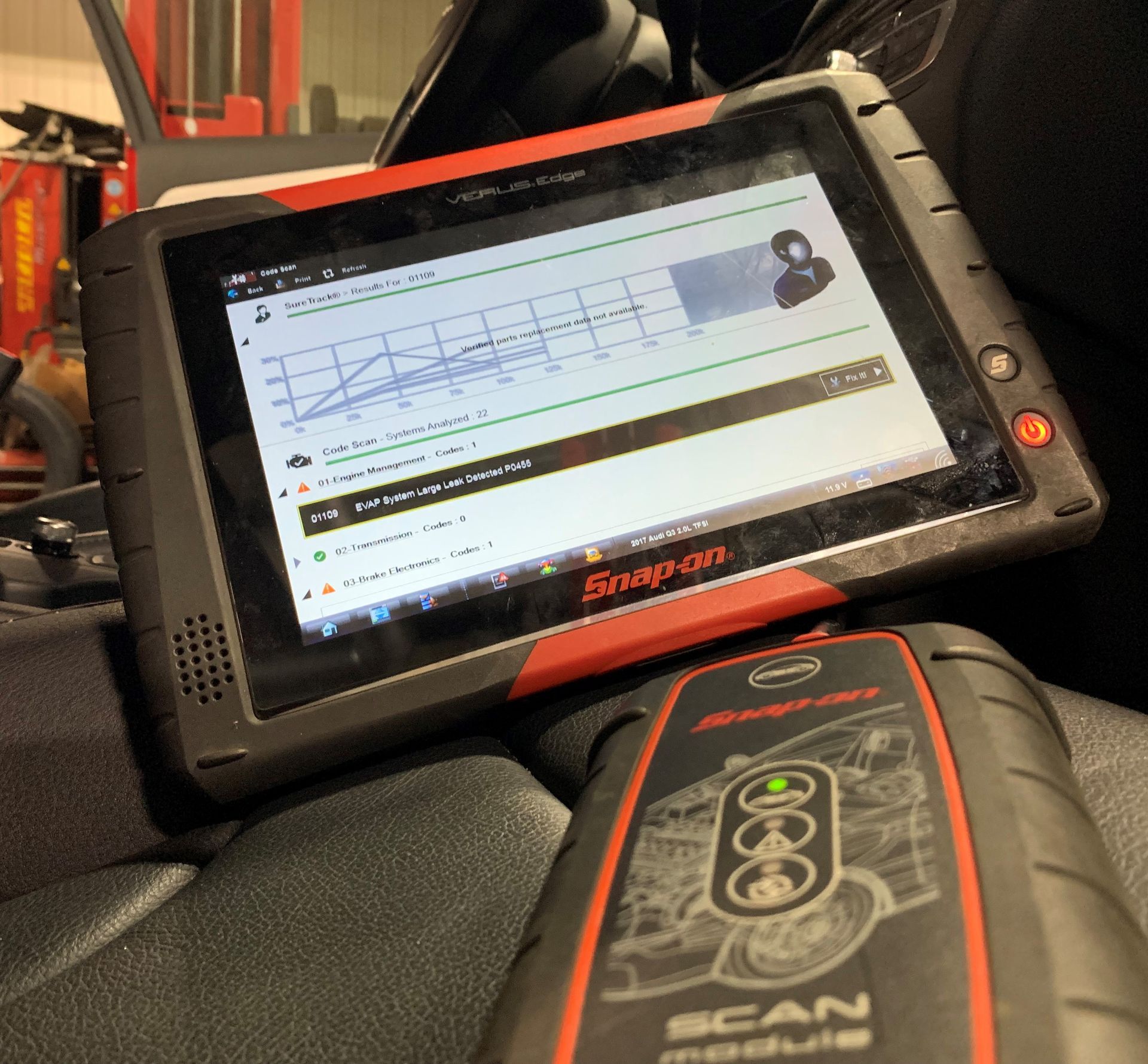 A snap on tablet is sitting next to a scan module  | Lou's Car Care Center, Inc.