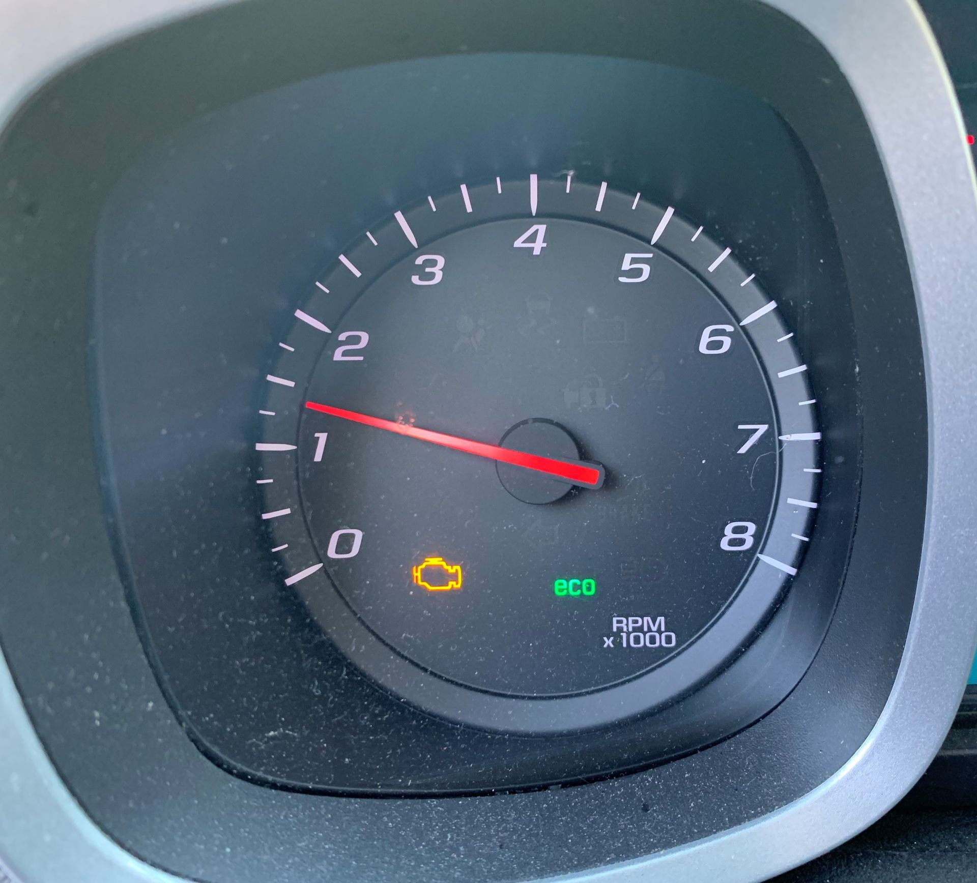 A close up of a car 's speedometer with a yellow c on it  | Lou's Car Care Center, Inc.