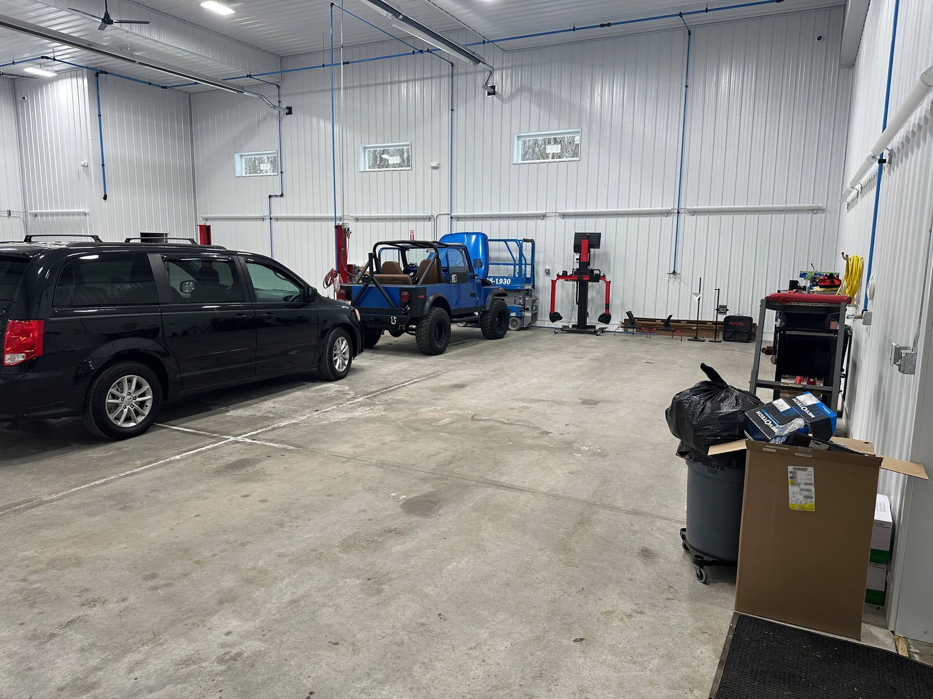 Blue Jeep and Black van in Medium Duty Truck Shop | Lou's Car Care Center, Inc.