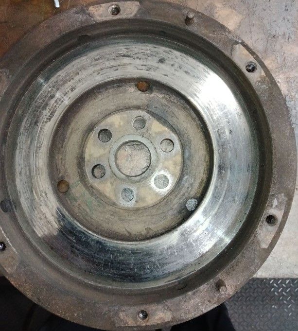 A close up of a clutch disc on a table.  | Lou's Car Care Center, Inc.