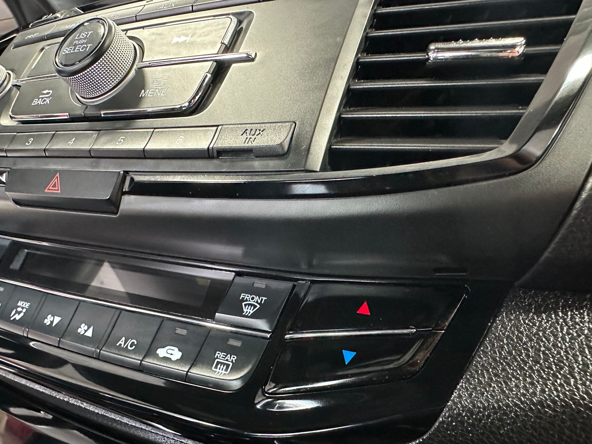 A close up of a car dashboard with a radio and air conditioning controls. | Lou's Car Care Center