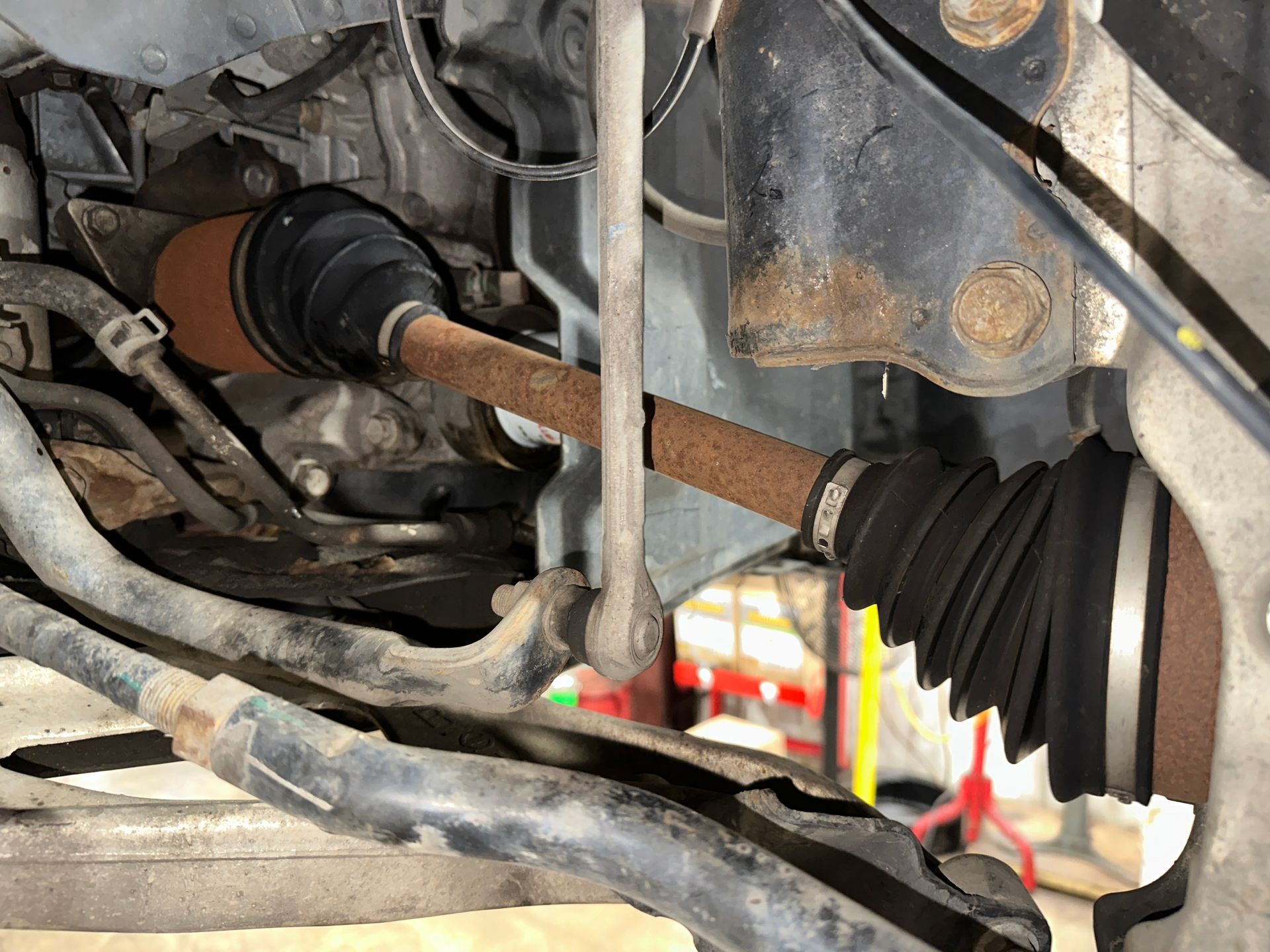 A close up of a drive shaft on a car. | Lou's Car Care Center, Inc.