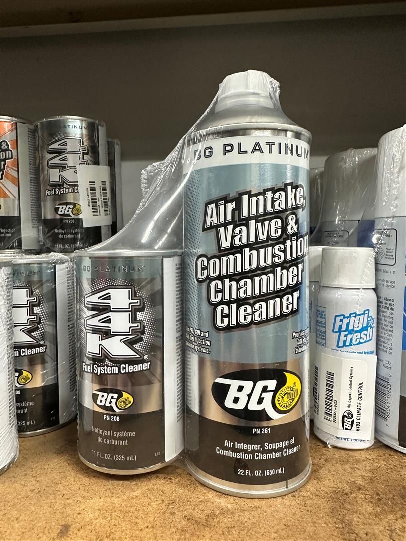 A bottle of air intake valve and combustion chamber cleaner is sitting on a table. | Lou's Car Care Center