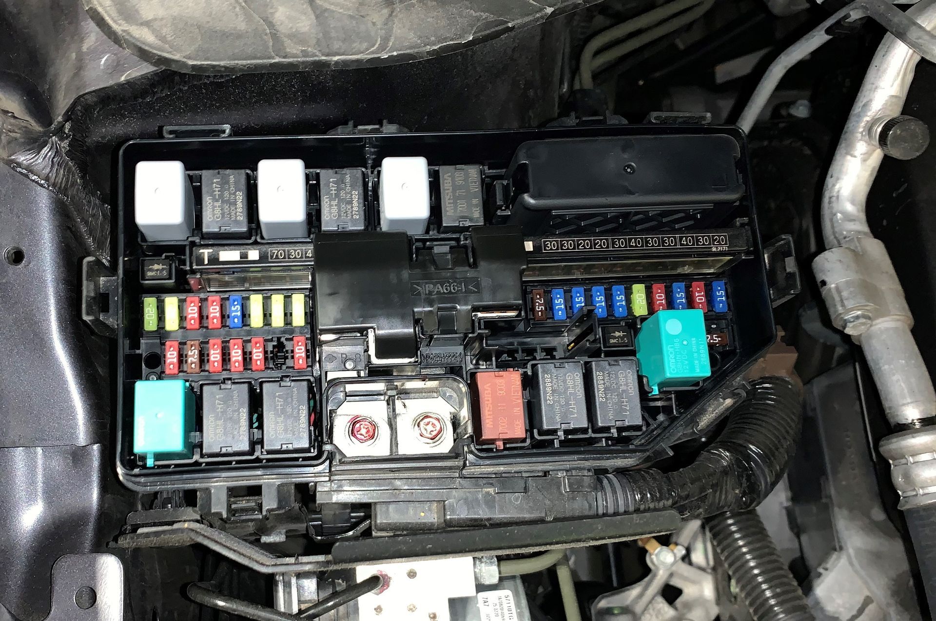 A fuse box is sitting under the hood of a car.  | Lou's Car Care Center, Inc.