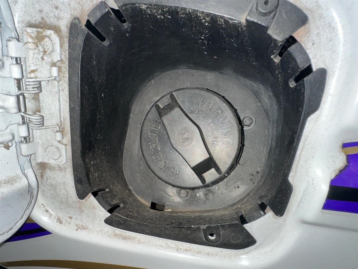 A close up of a fuel cap on a car  | Lou's Car Care Center, Inc.