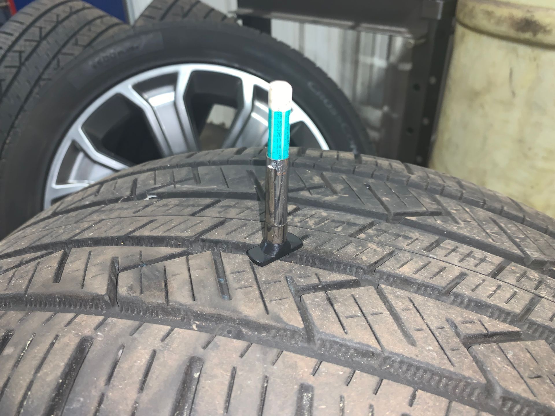 A tire with a needle sticking out of it | Lou's Car Care Center Inc.