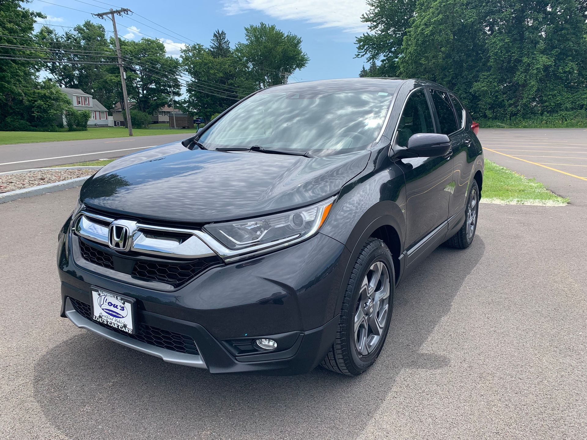 A black honda cr v is parked in a parking lot.  | Lou's Car Care Center, Inc.