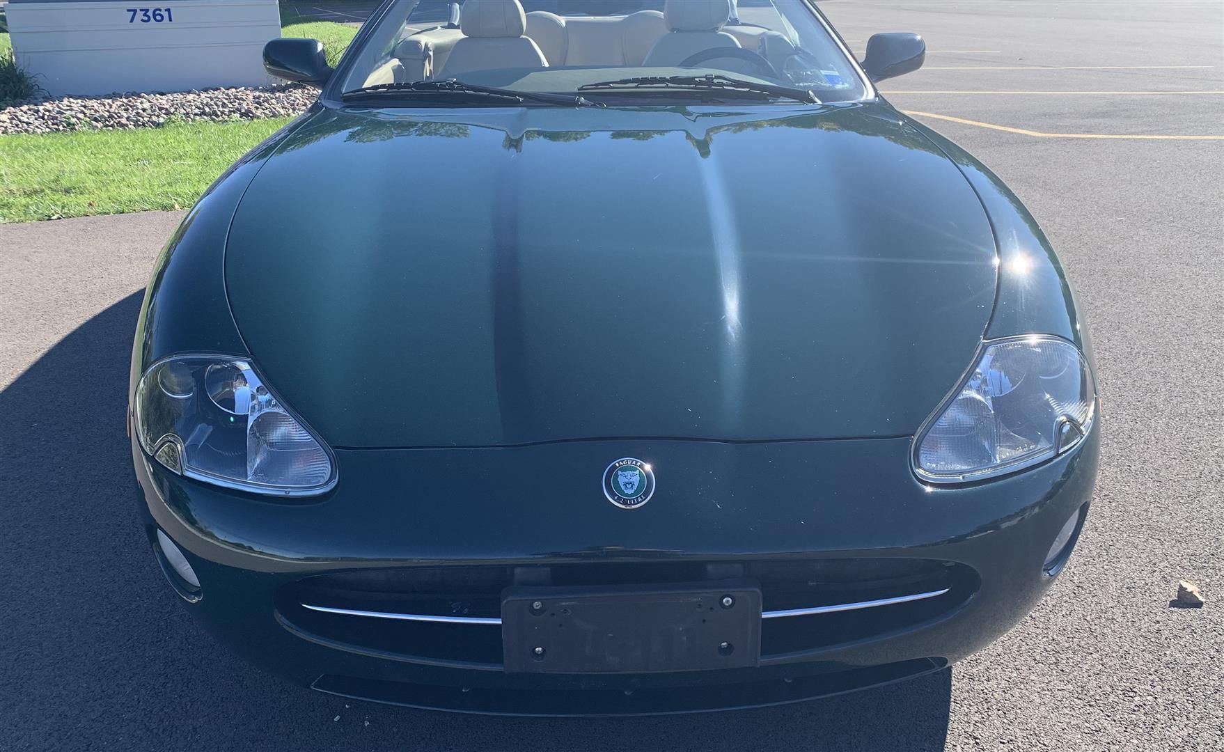 A black sports car is parked on the side of the road. | Lou's Car Care Center Inc.