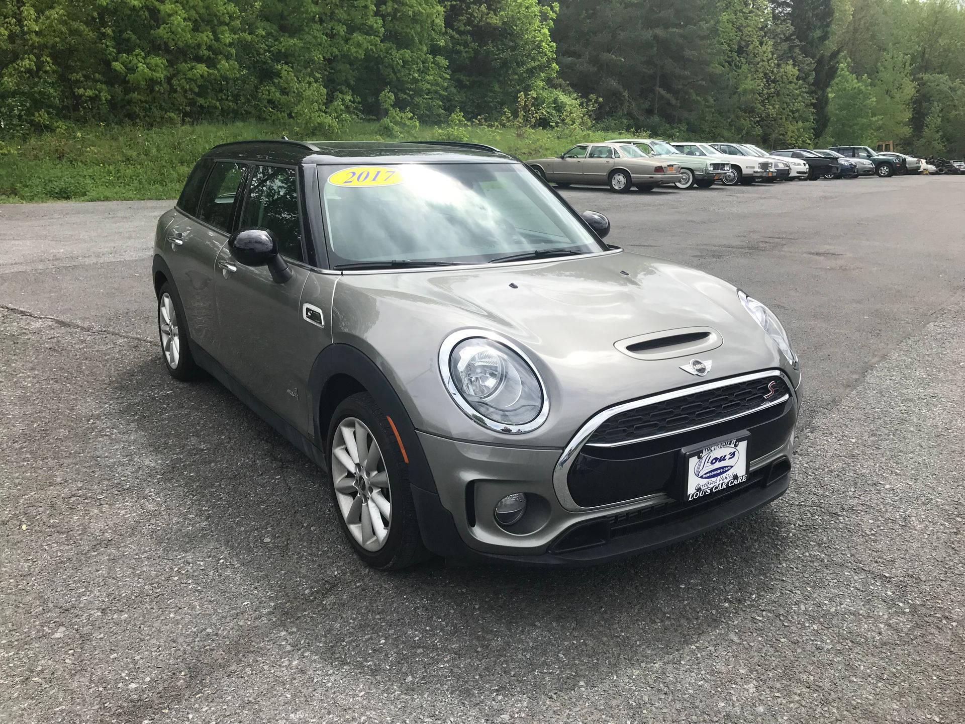 A gray mini cooper clubman is parked in a parking lot. | Lou's Car Care Center, Inc.