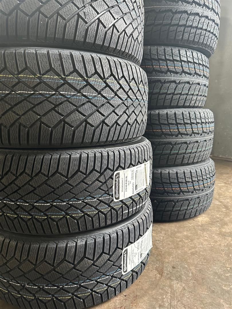 A pile of tires stacked on top of each other on a table. | Lou's Car Care Center