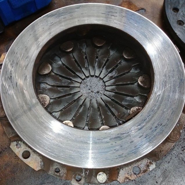 A close up of a metal disc with holes in it  | Lou's Car Care Center, Inc.