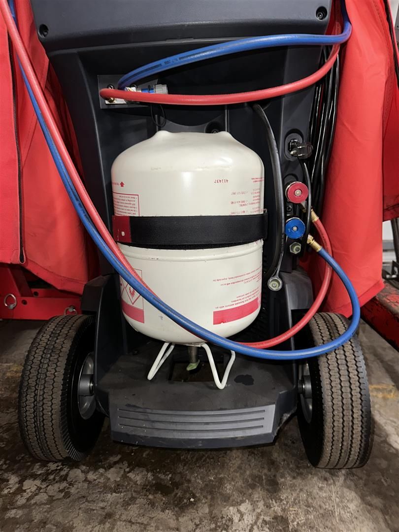 A propane tank is attached to a machine with wheels | Lou's Car Care Center