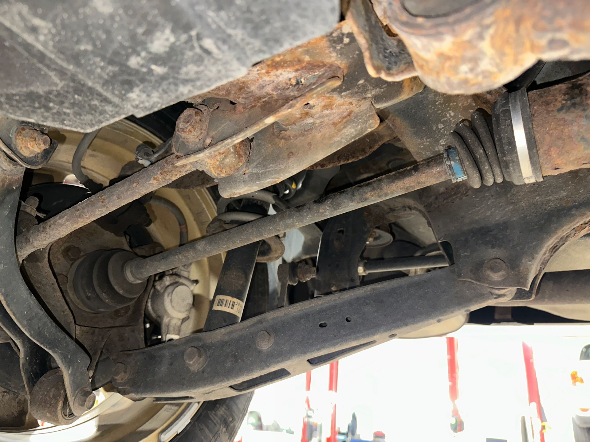 A close up of the underside of a car with rust on it. | Lou's Car Care Center, Inc.