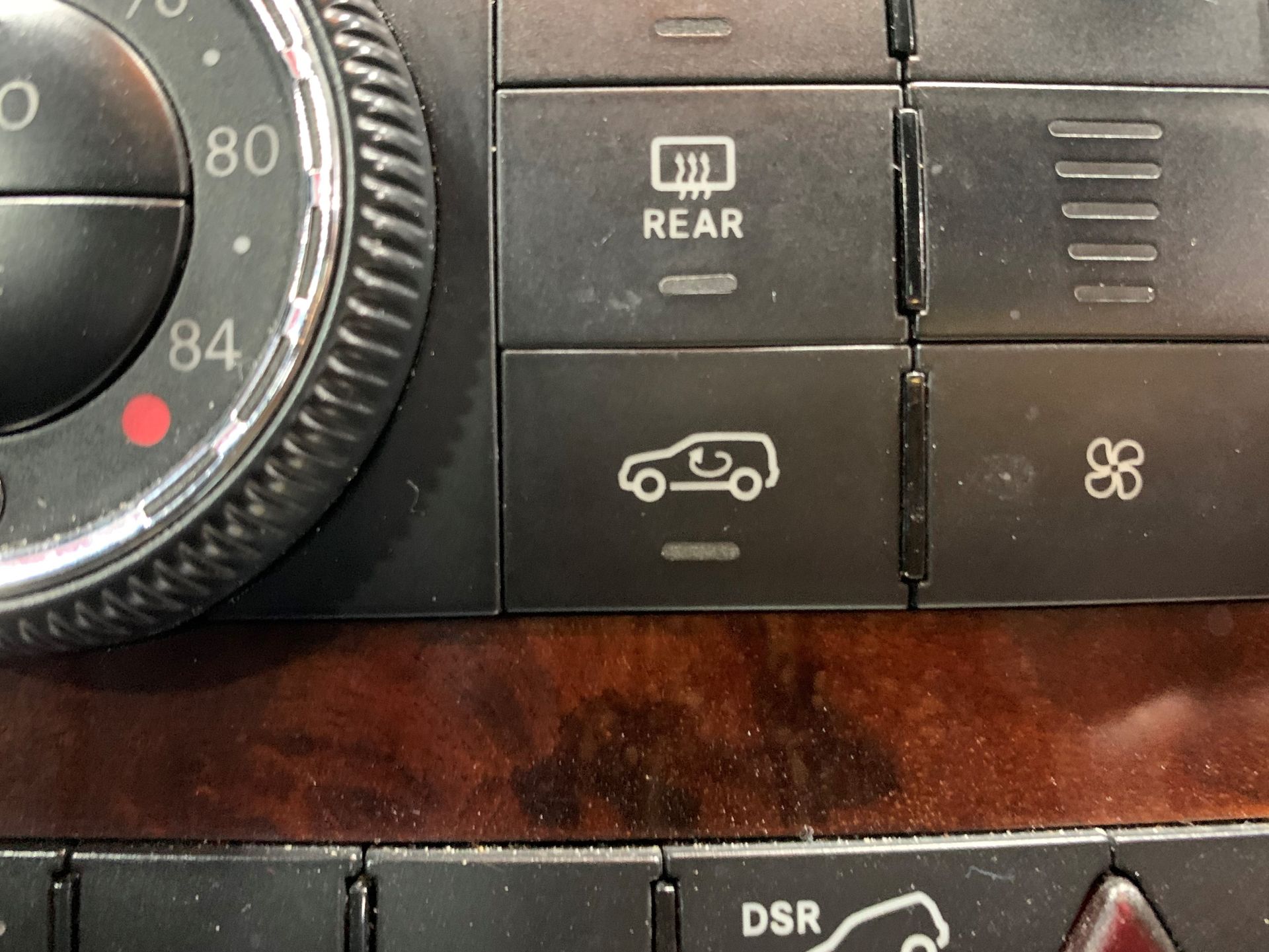 A close up of a car dashboard with a rear button  | Lou's Car Care  Center Inc.