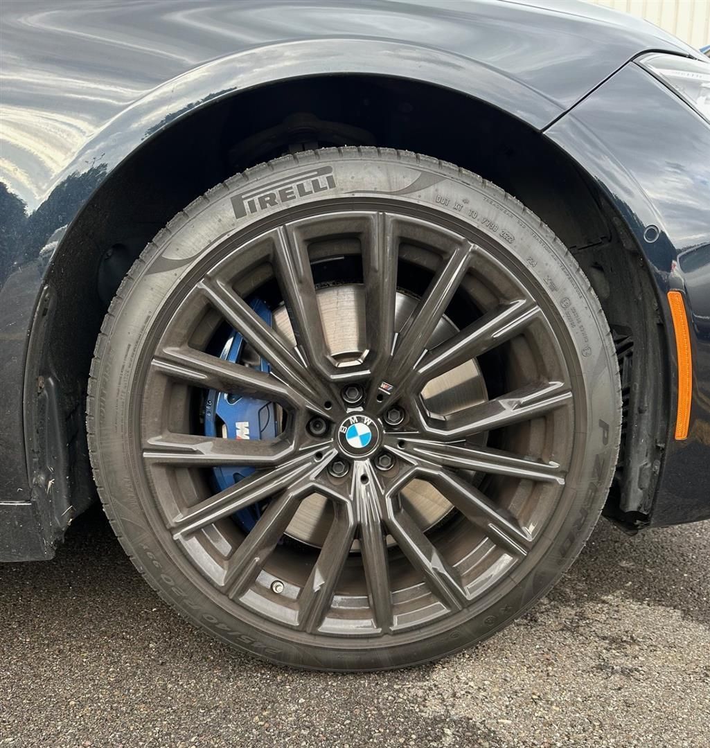 A close up of a car wheel with a tire on it.  | Lou's Car Care Center, Inc.