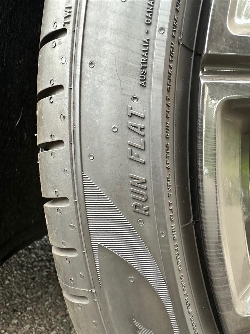 A close up of a tire on a car.  | Lou's Car Care Center, Inc.