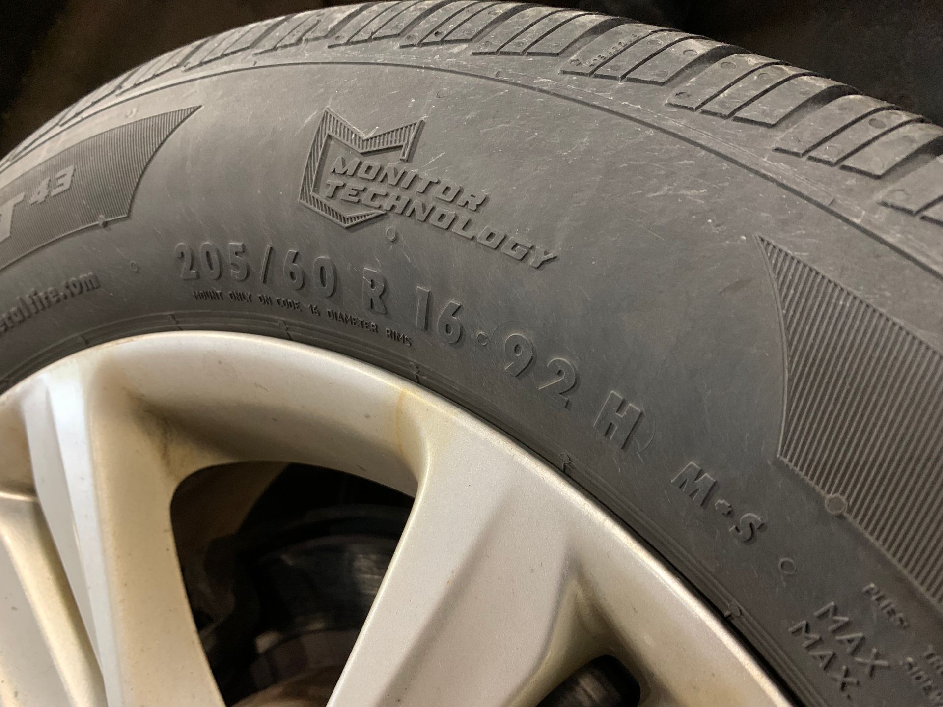 A close up of a tire on a car wheel  | Lou's Car Care Center, Inc.