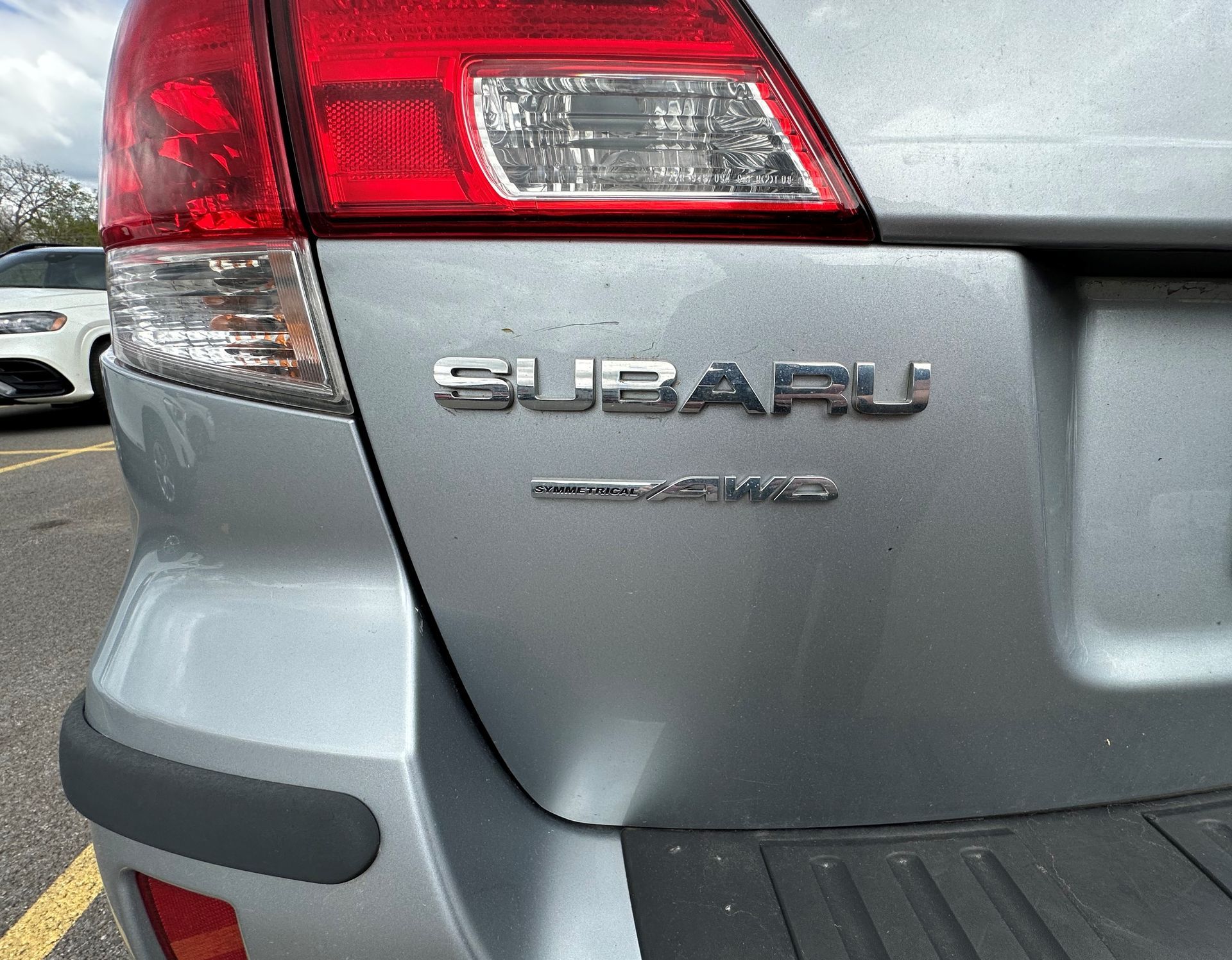 A silver subaru is parked in a parking lot. | Lou's Car Care Center Inc.