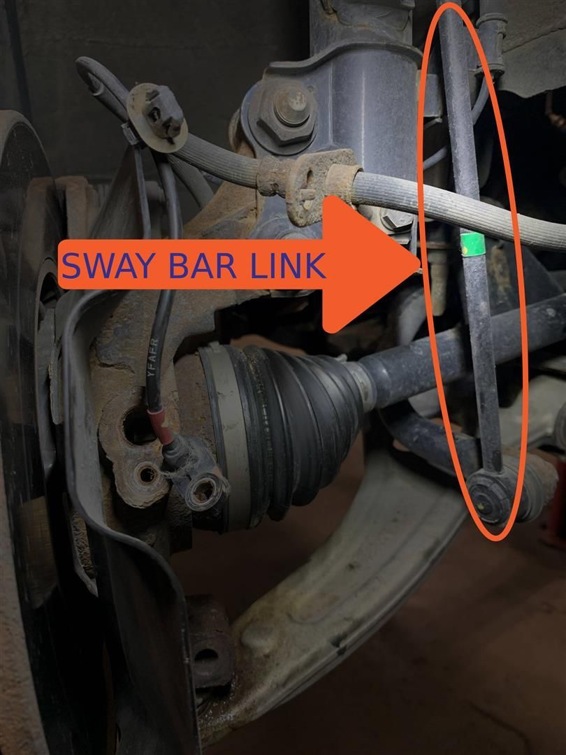 A close up of a sway bar link on a car | Lou's Car Care Center, Inc.