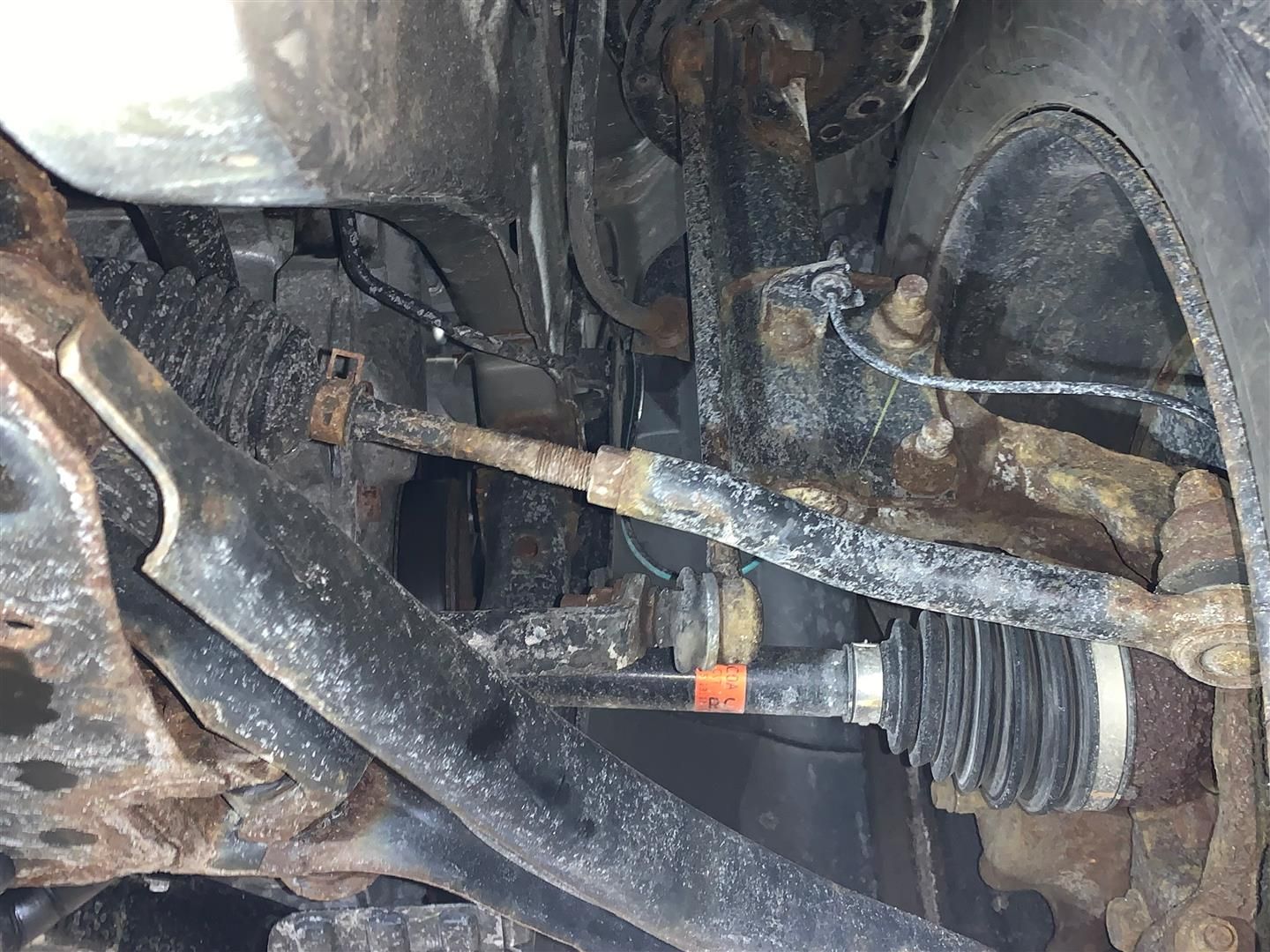 A close up of a rusty suspension system on a car. | Lou's Car Care Center Inc.