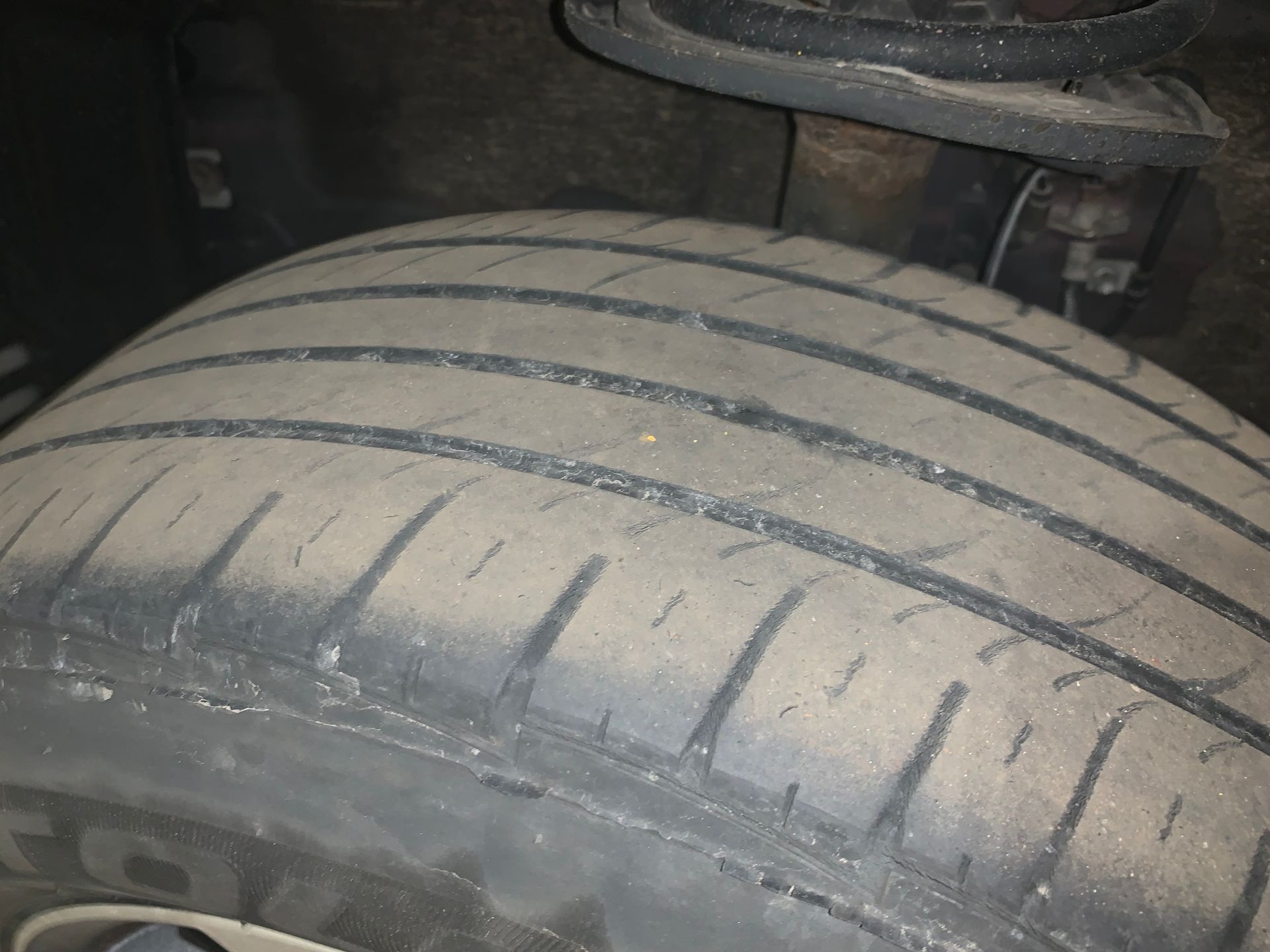 A close up of a tire on a car | Lou's Car Care Center Inc.