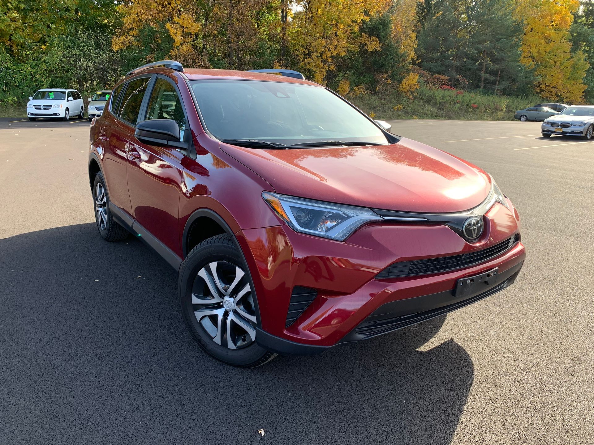 A red Toyota Rav 4 is parked in a parking lot. | Lou's Car Care Center, Inc.