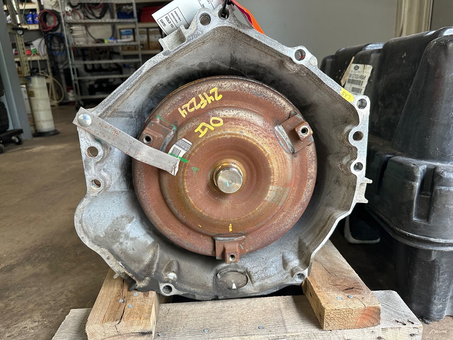 A gearbox is sitting on top of a wooden pallet.  | Lou's Car Care Center, Inc.