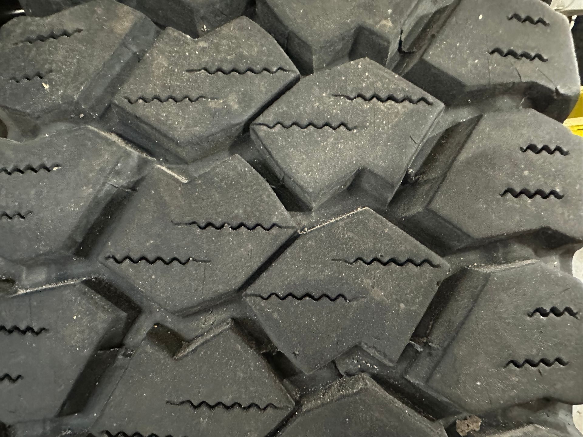 A close up of a tire with a lot of holes in it | Lou's Car Care Center Inc.