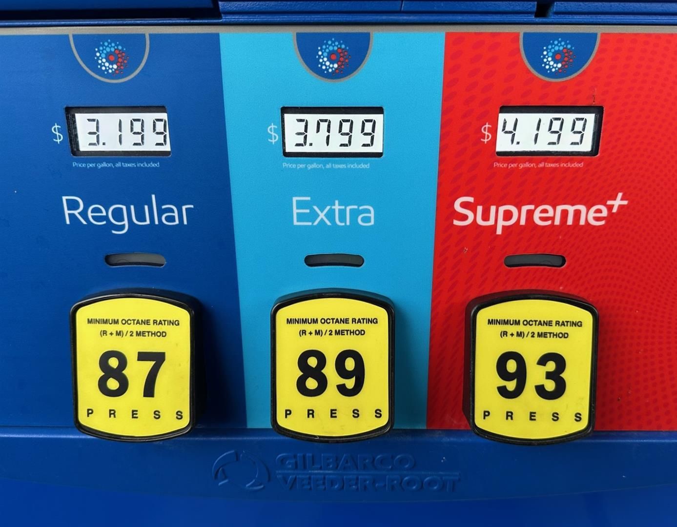 Three gas pumps with regular extra and supreme on them | Lou's Car Care Center