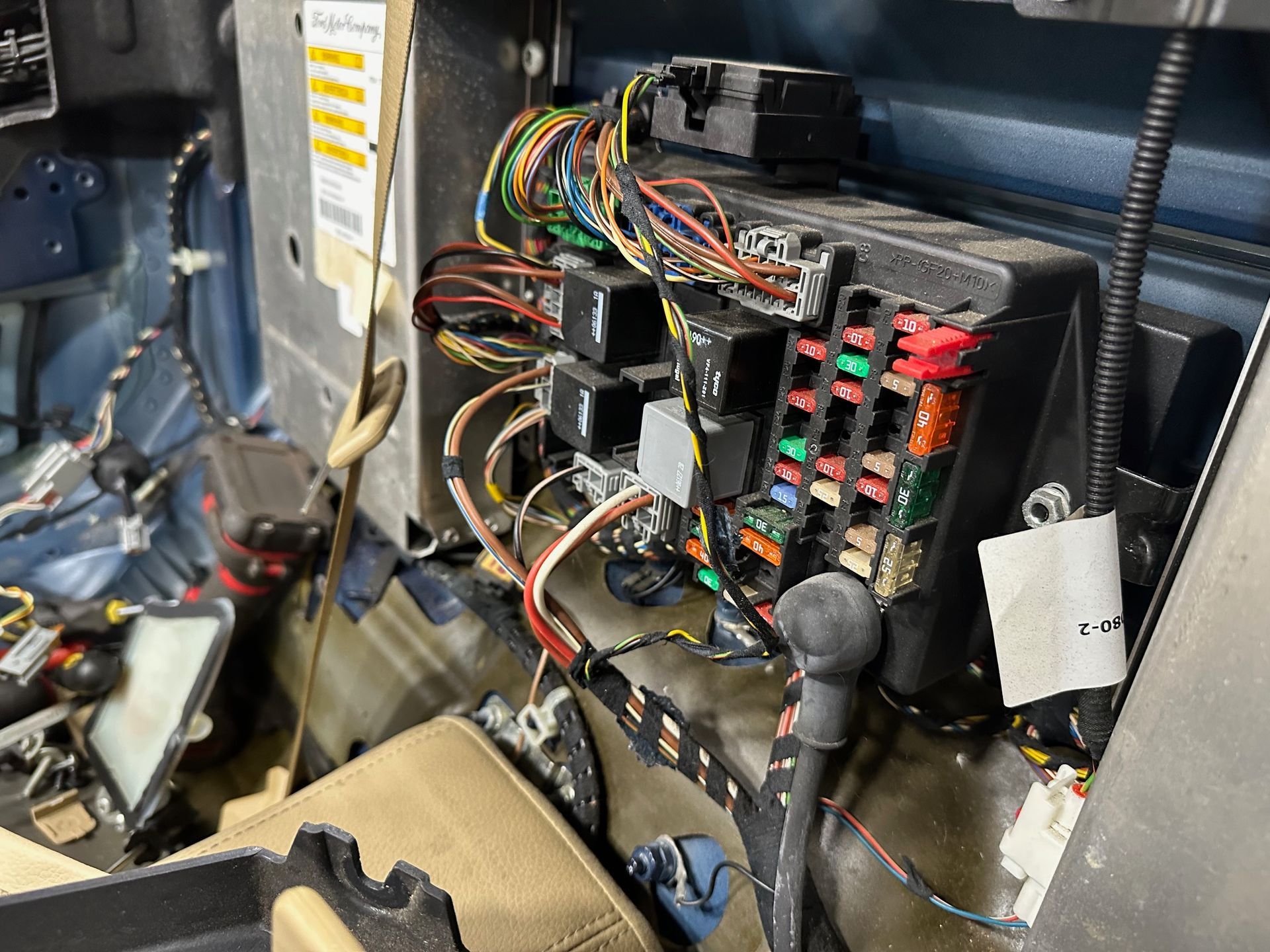 Electrical wires and fuses in a fuse box in a car | Lou's Car Care Center, Inc.