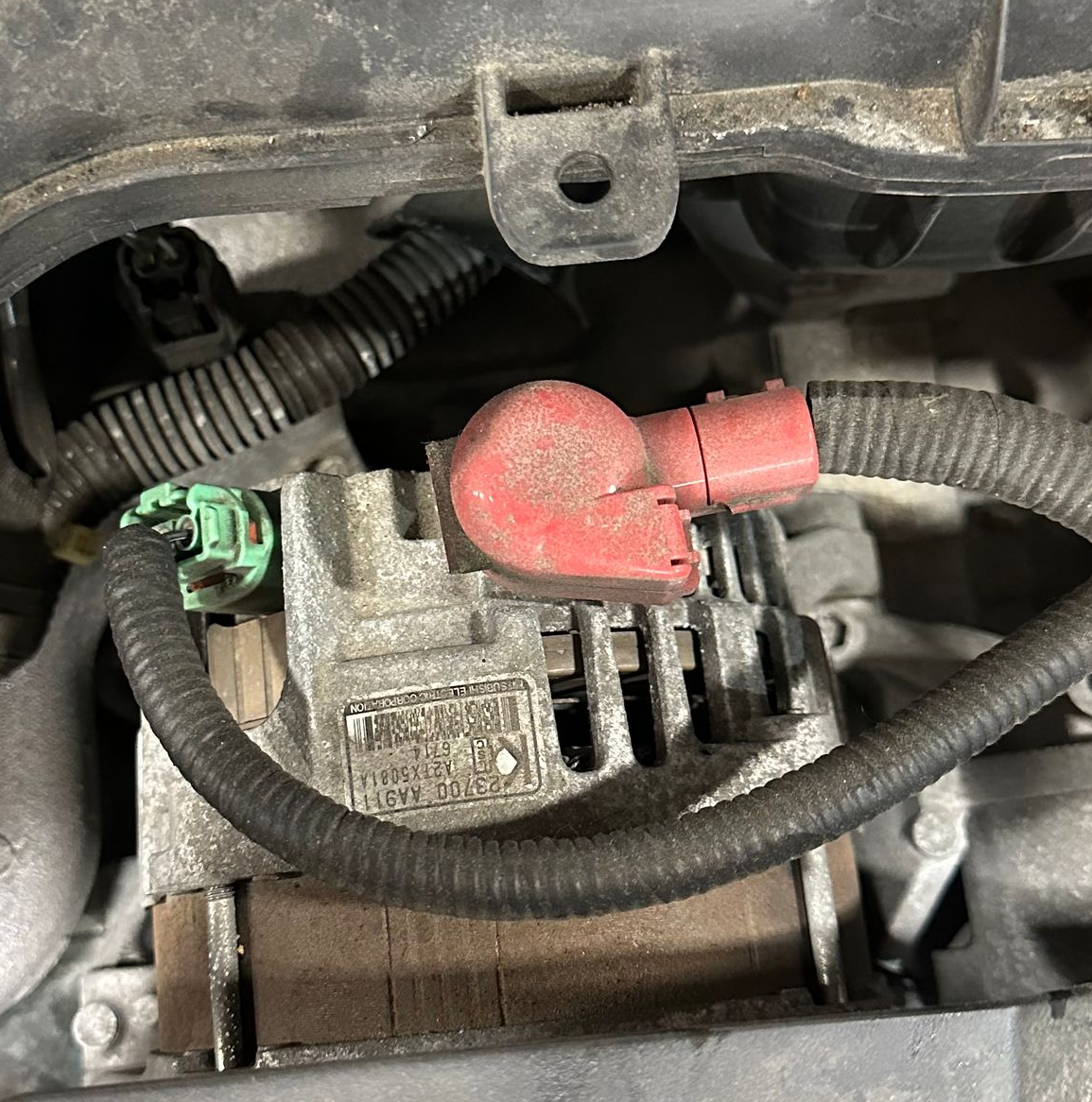 An alternator in a vehicle engine bay comparment.