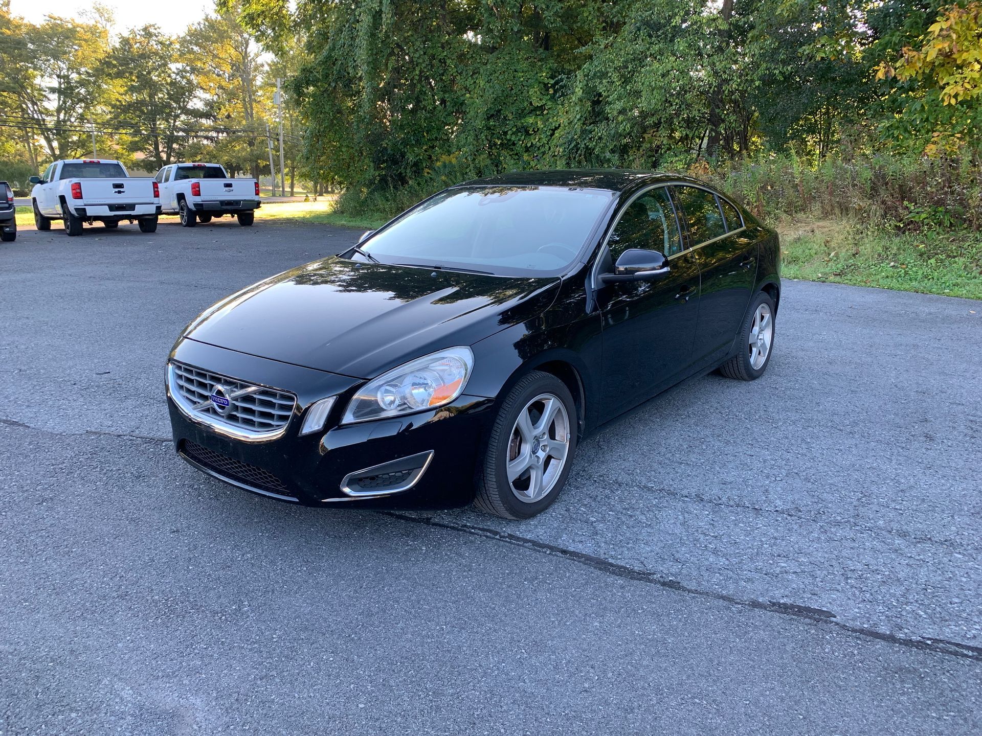 A black volvo s60 is parked in a parking lot. | Lou's Car Care Center, Inc.