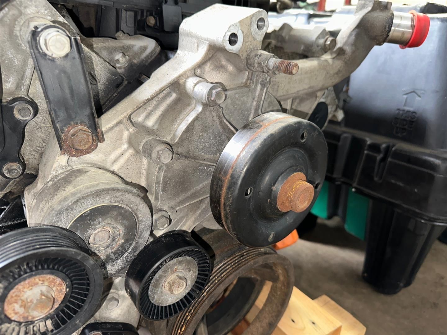 A close up of a water pump on a car engine. | Lou's Car Care Center, Inc.