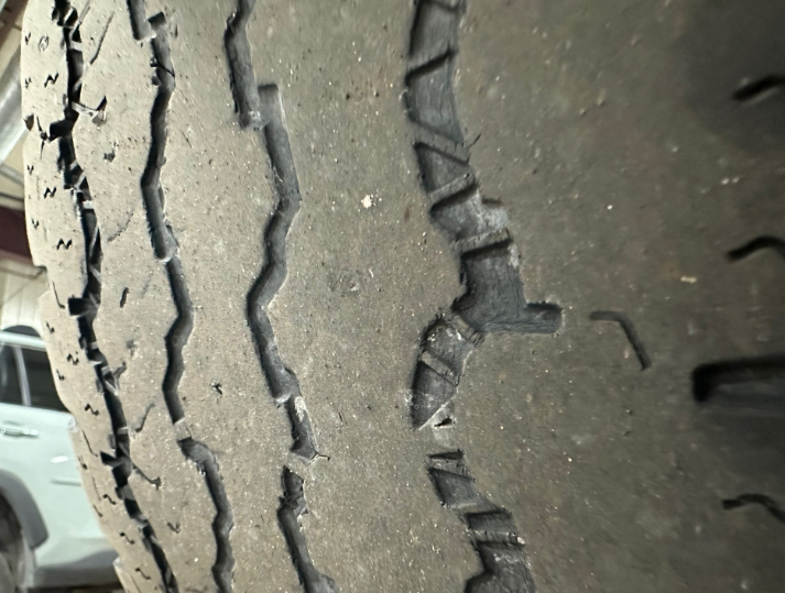Worn out tire tread on a vehicle wheel | Lou's Car Care Center, Inc.