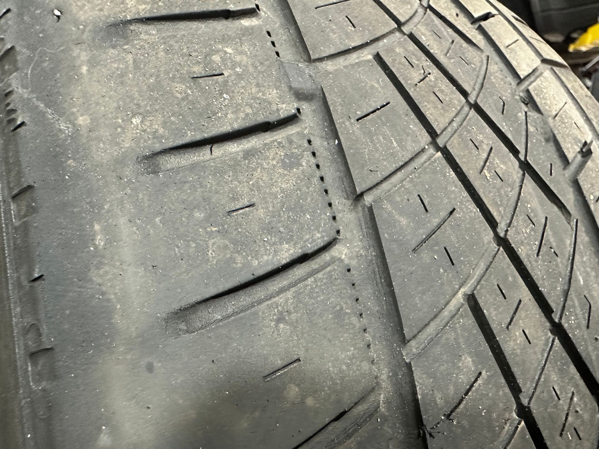 A close up of a tire with a lot of holes in it.  | Lou's Car Care Center, Inc.