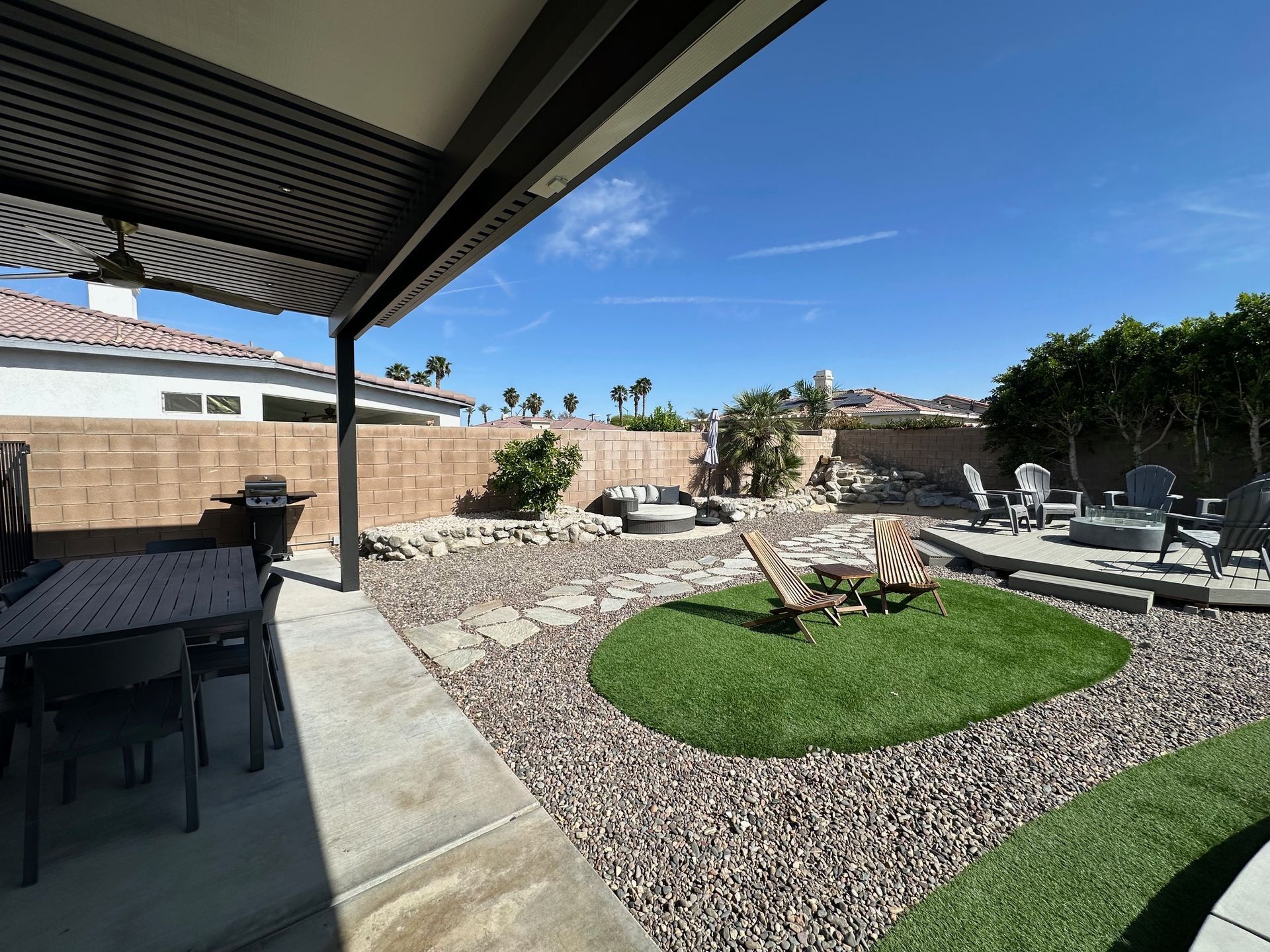 Patio with outdoor dining set and lounge area with fire pit