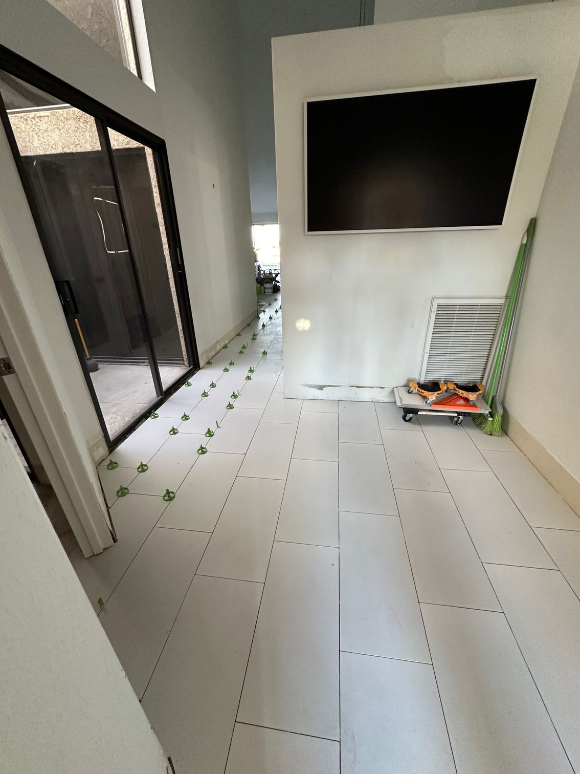 Hallway with white tile flooring in progress